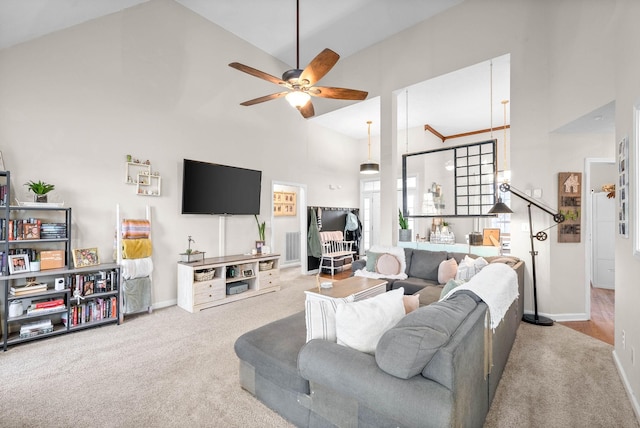 carpeted living room featuring ceiling fan and high vaulted ceiling