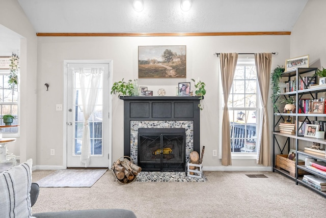 carpeted living room with lofted ceiling, crown molding, and a textured ceiling