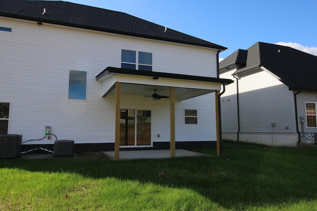 rear view of property with ceiling fan, central AC, and a yard