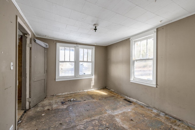 spare room with plenty of natural light and crown molding