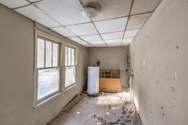 interior space with a drop ceiling and water heater