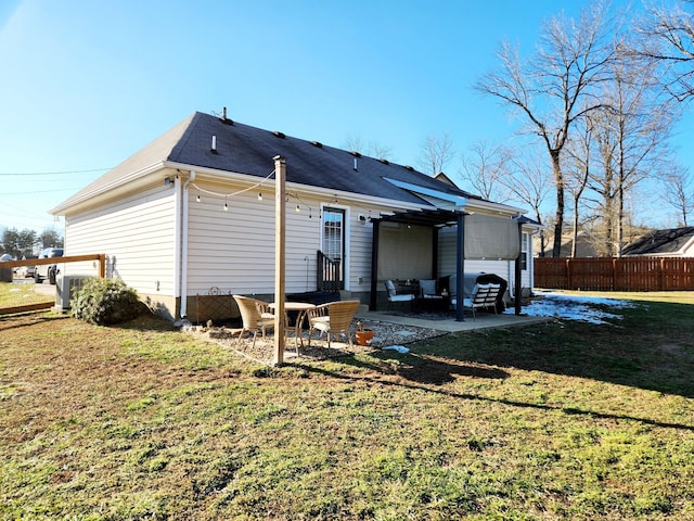 rear view of house featuring a lawn and a patio