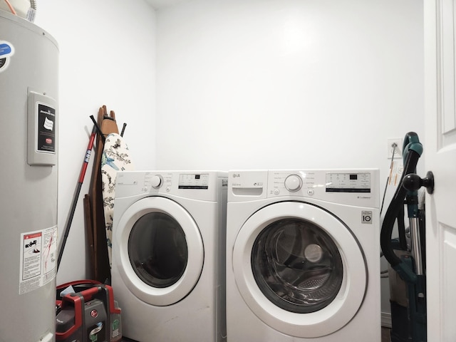 washroom featuring washing machine and clothes dryer and electric water heater