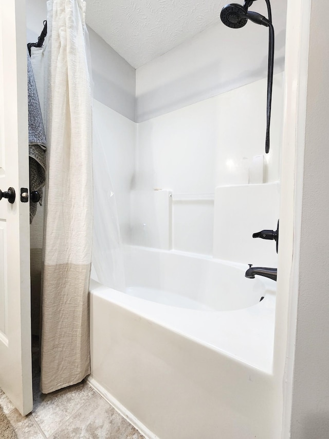 bathroom with tile patterned flooring, a textured ceiling, and shower / tub combo with curtain