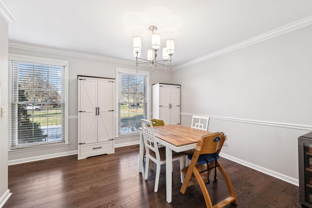 dining area with dark wood-type flooring, ornamental molding, and a chandelier