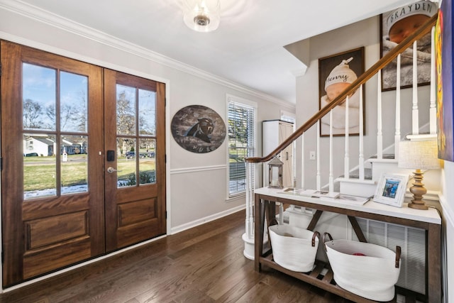 foyer with dark wood-type flooring, ornamental molding, and french doors