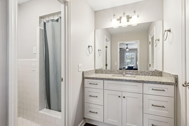 bathroom featuring ceiling fan, vanity, and curtained shower