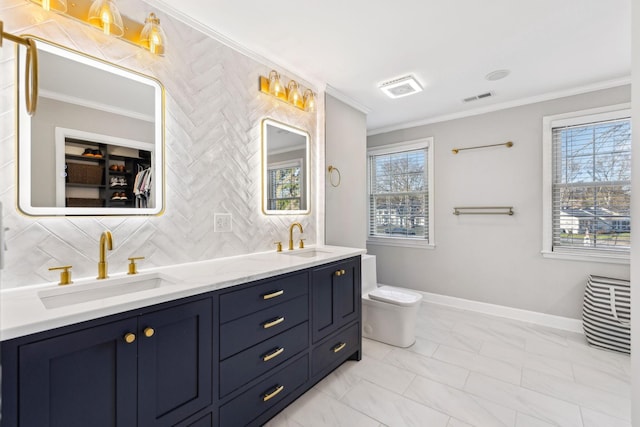 bathroom with toilet, vanity, crown molding, and tasteful backsplash