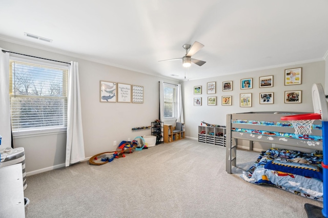 carpeted bedroom with ceiling fan, crown molding, and multiple windows