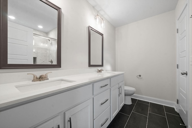 bathroom featuring toilet, vanity, tile patterned floors, and a shower with door