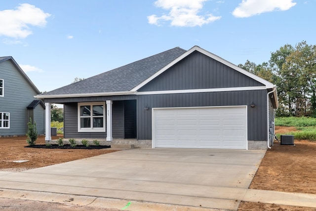 view of front of property featuring cooling unit and a garage