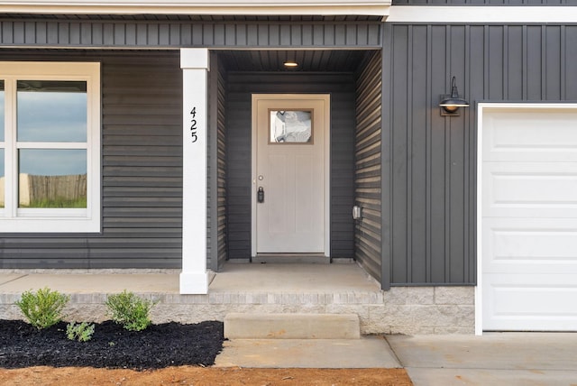 doorway to property with a garage