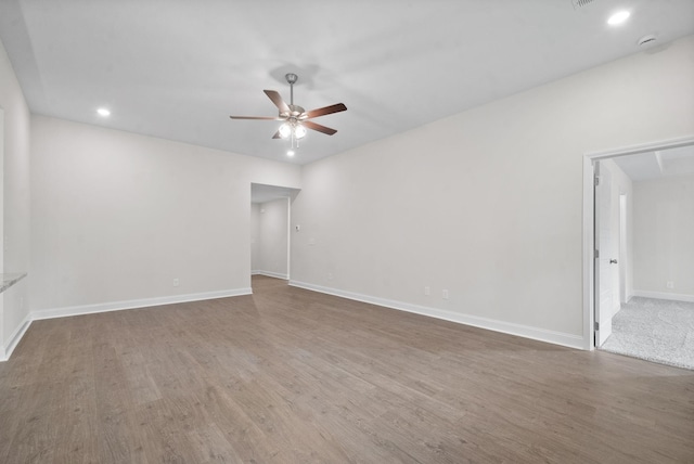 empty room featuring ceiling fan and hardwood / wood-style floors