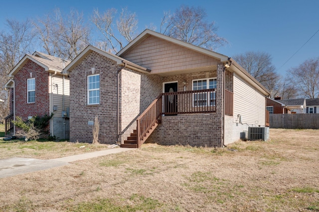 bungalow with cooling unit and a front yard