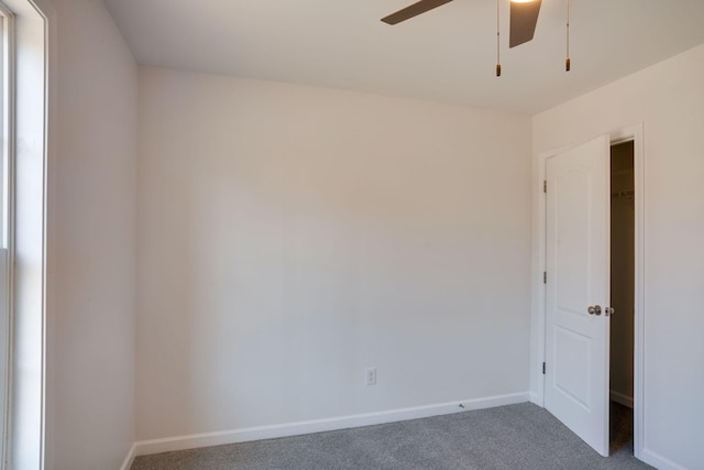 carpeted empty room featuring ceiling fan