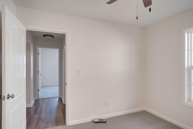 unfurnished room with ceiling fan and dark hardwood / wood-style flooring