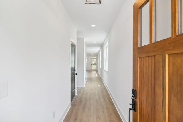 hall with light hardwood / wood-style floors