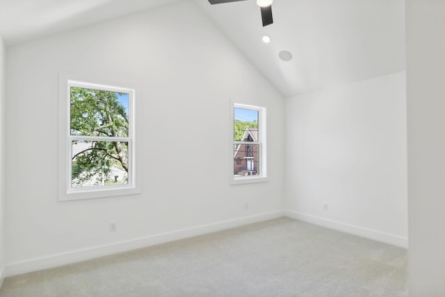 carpeted empty room with ceiling fan and high vaulted ceiling