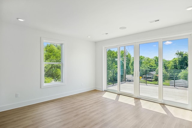 spare room with light wood-type flooring