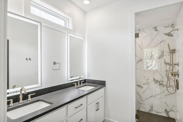 bathroom with vanity and tiled shower