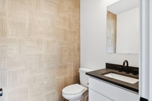 bathroom with toilet and vanity