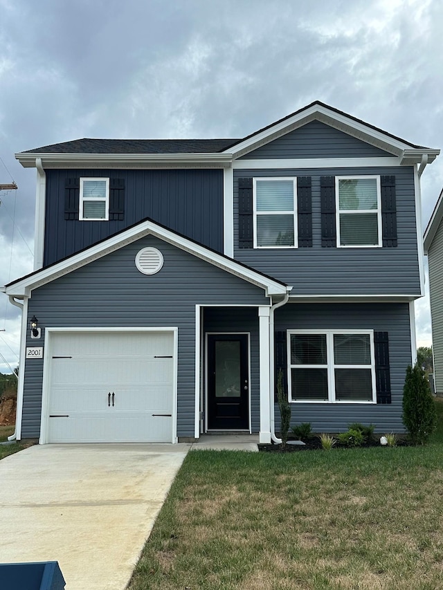 view of front of home with a garage and a front yard