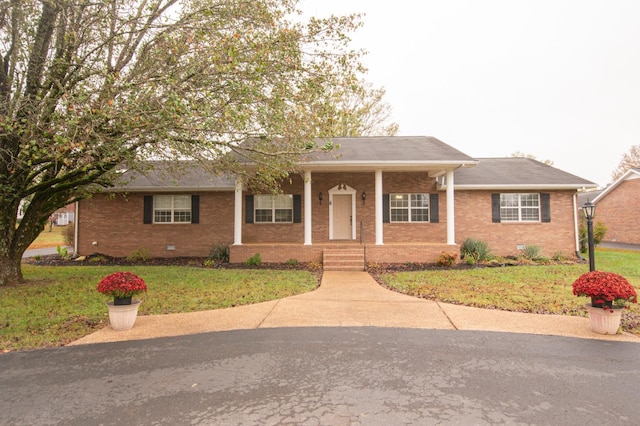 view of front of house with a front lawn and a porch