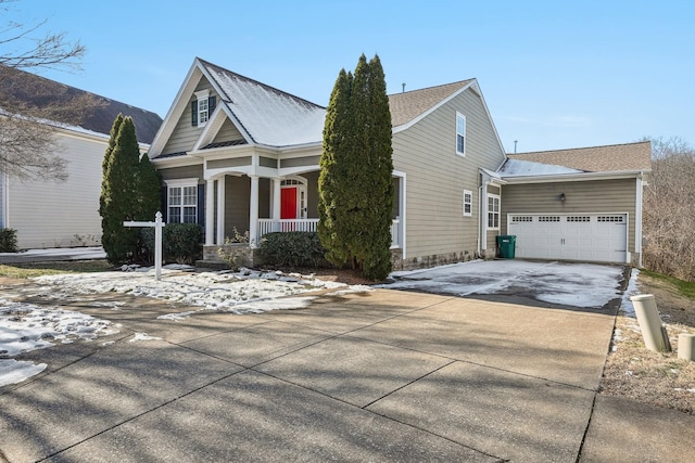 view of front of home with covered porch and a garage