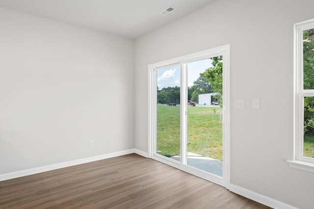 unfurnished room featuring hardwood / wood-style flooring