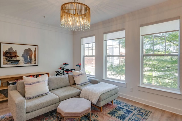 living room featuring a chandelier, crown molding, and hardwood / wood-style flooring