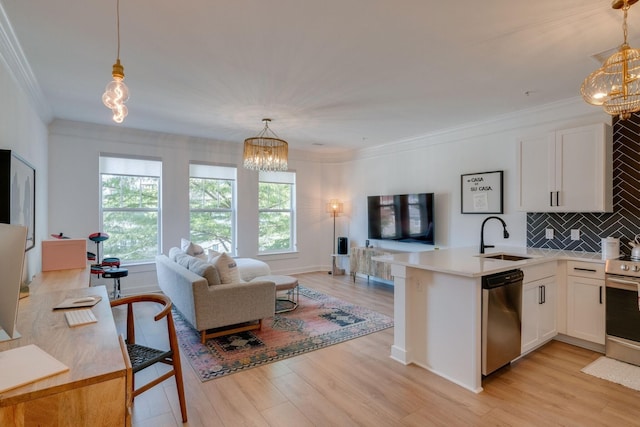 kitchen featuring appliances with stainless steel finishes, white cabinetry, hanging light fixtures, and sink