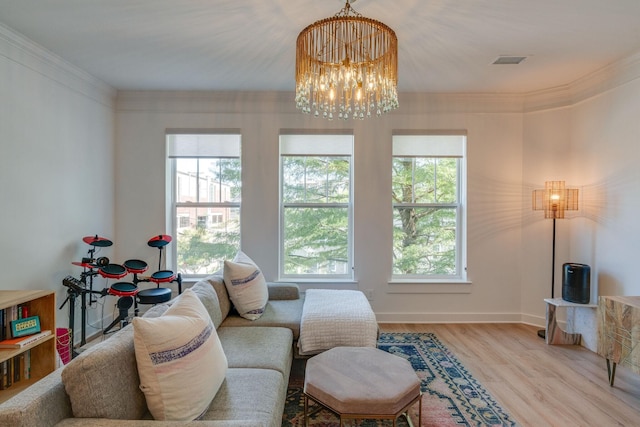 living room featuring ornamental molding, light hardwood / wood-style floors, and a notable chandelier