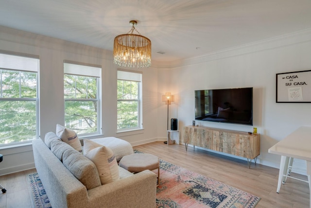 living room with a healthy amount of sunlight, light hardwood / wood-style flooring, and a notable chandelier