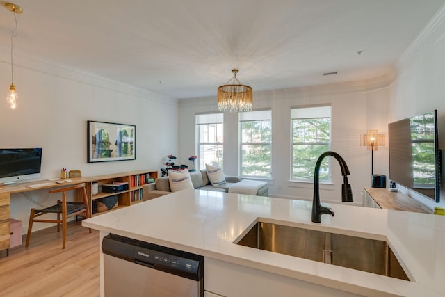 kitchen with an inviting chandelier, pendant lighting, dishwasher, and sink