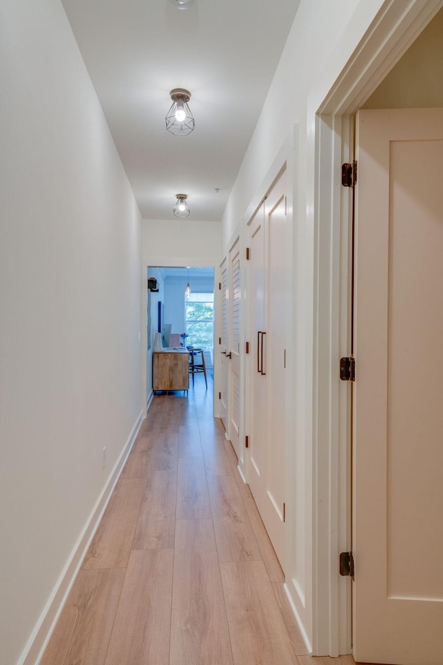 corridor with light hardwood / wood-style flooring