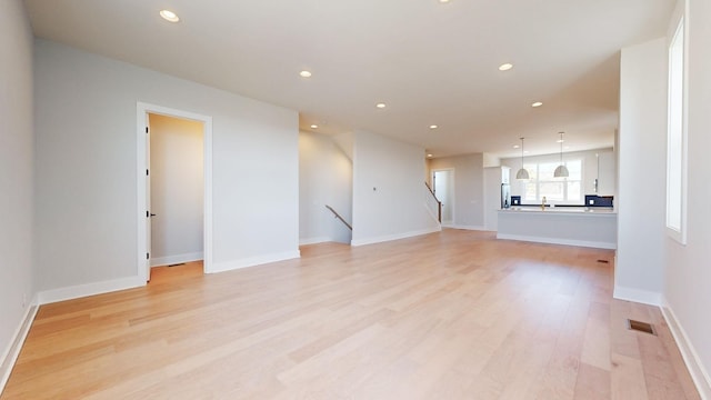 unfurnished living room featuring light hardwood / wood-style floors