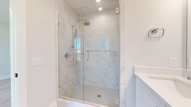 bathroom featuring vanity and an enclosed shower