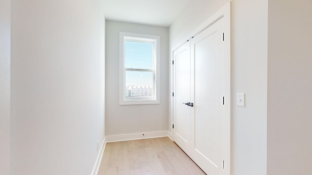 corridor with light hardwood / wood-style flooring