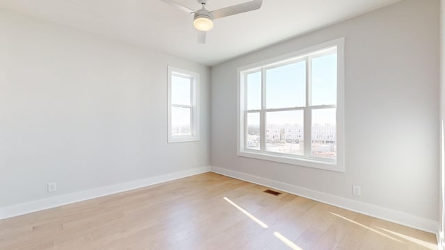 spare room with ceiling fan and light hardwood / wood-style flooring