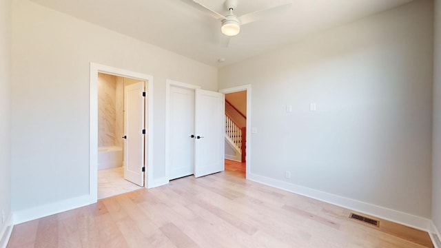 unfurnished bedroom with light hardwood / wood-style flooring, ceiling fan, and ensuite bathroom