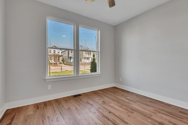 unfurnished room with light wood-type flooring and ceiling fan