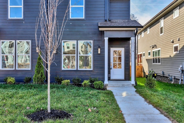 property entrance featuring a lawn