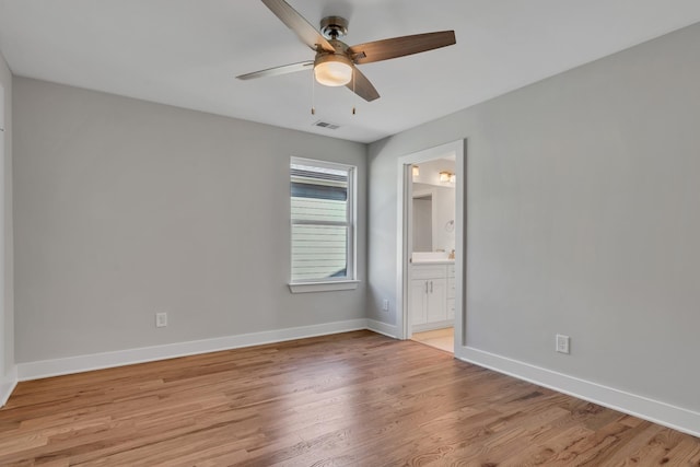 unfurnished bedroom with ceiling fan, connected bathroom, and light wood-type flooring