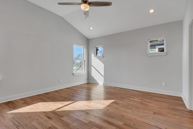 unfurnished room with ceiling fan, lofted ceiling, and light wood-type flooring