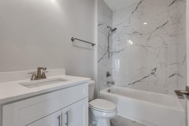 full bathroom with toilet, vanity, and tiled shower / bath