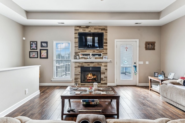 living room featuring dark hardwood / wood-style floors and a fireplace