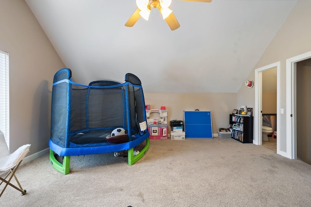 playroom with ceiling fan, carpet flooring, and lofted ceiling