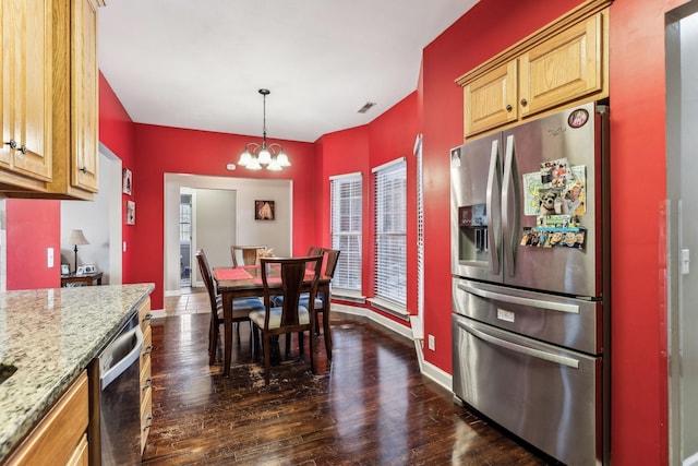 kitchen featuring hanging light fixtures, dark hardwood / wood-style floors, stainless steel appliances, and a chandelier