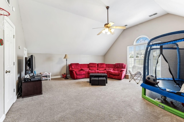 carpeted living room featuring ceiling fan and vaulted ceiling