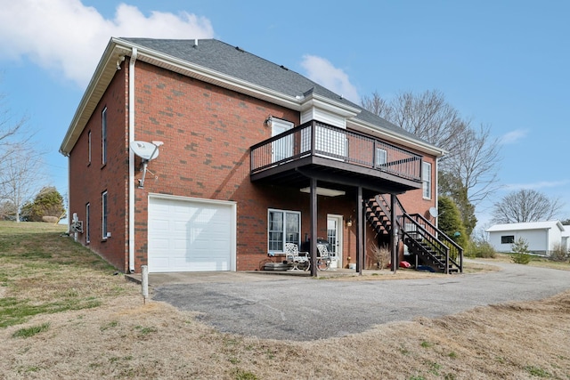 back of house featuring a deck and a garage